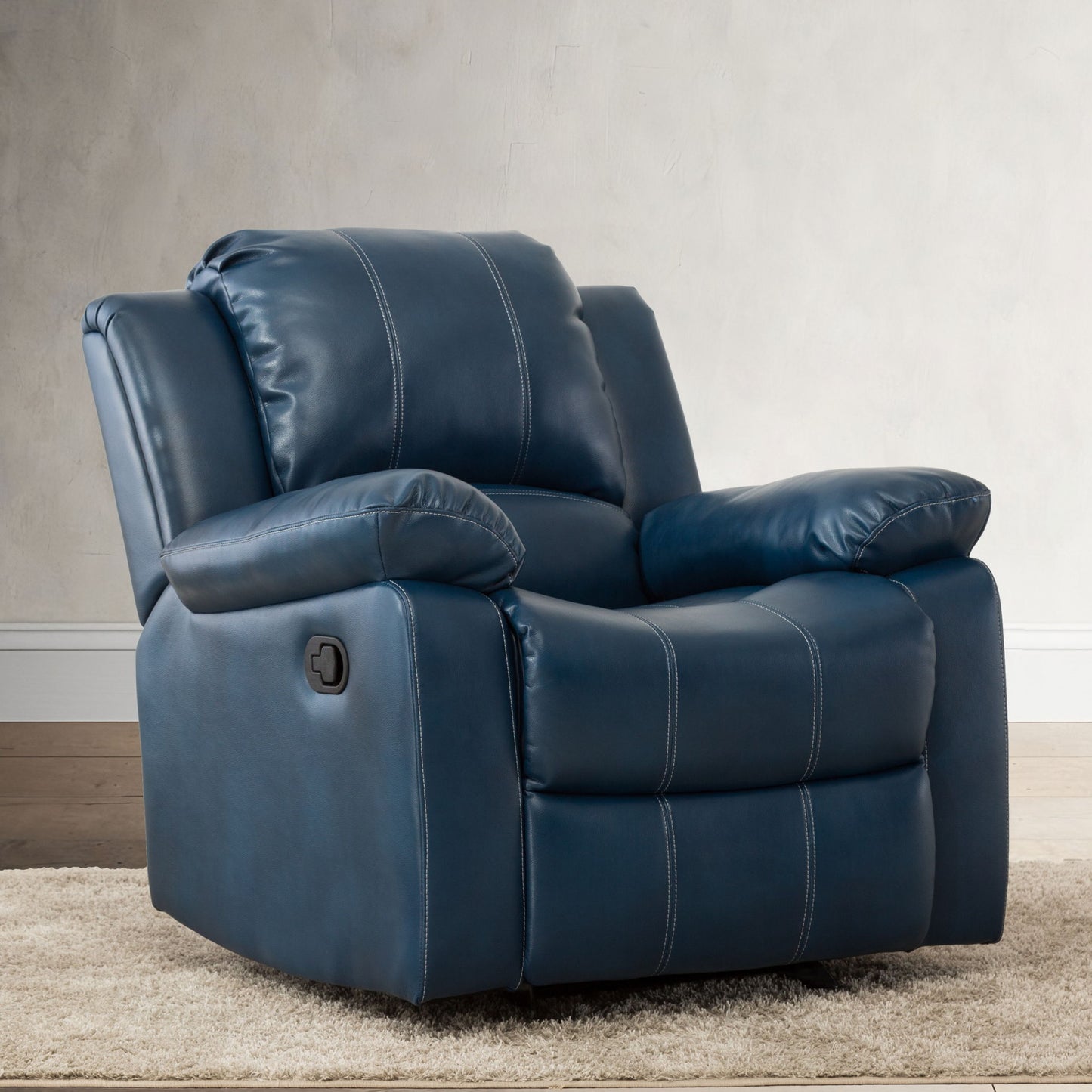 The Charlotte Glider Recliner with classic style, featuring plush dark blue leather and white stitching, is shown on a beige carpet beside a light wall and wood floor.