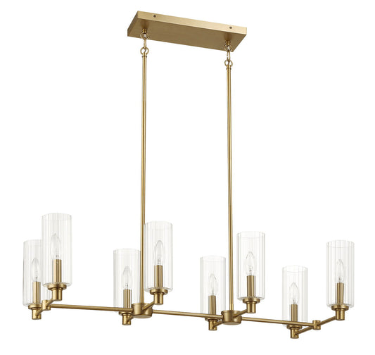 The Willow 8-Light Island features a modern rectangular chandelier in antique brass/gold, with clear ribbed pendant shades encasing candle-shaped bulbs, suspended by two rods from a rectangular ceiling mount.