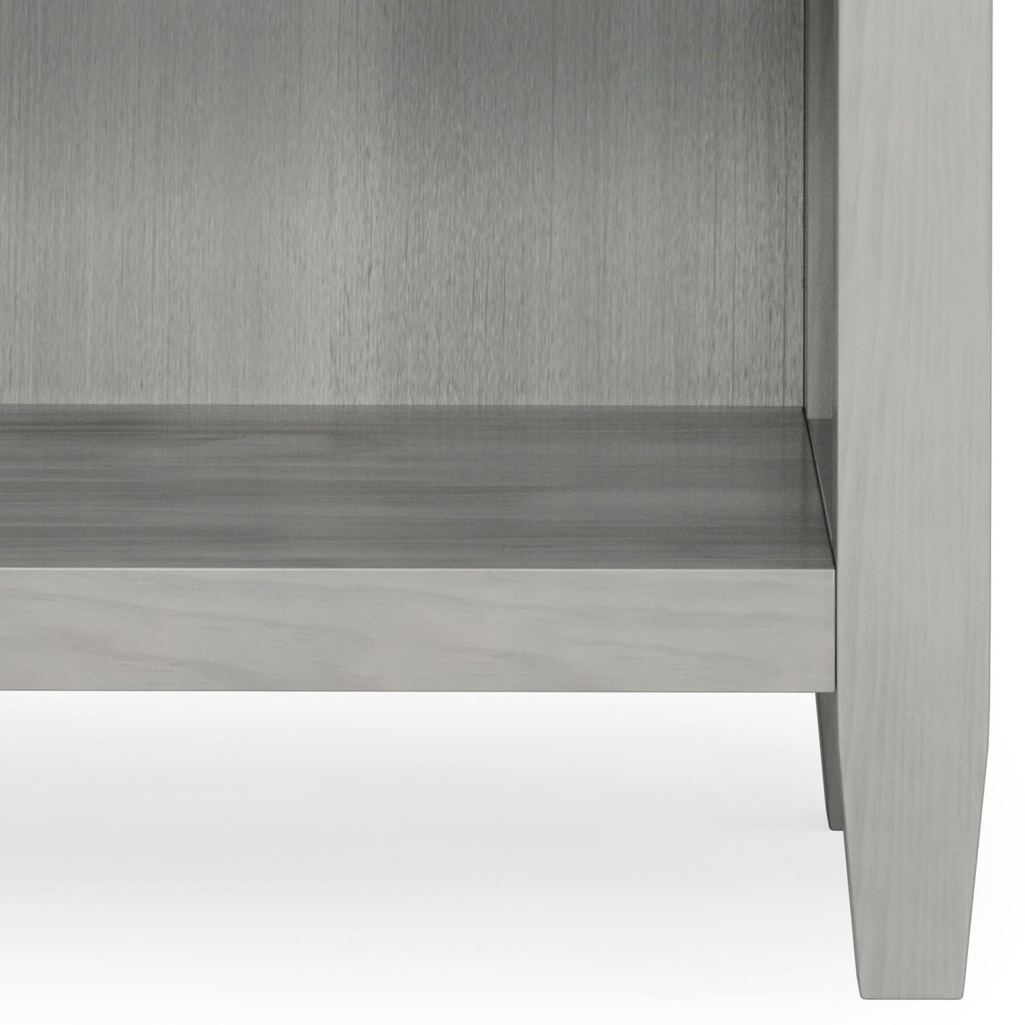 Lower portion of the Carlton - Bedside Table, Handcrafted, in light gray wood with four legs and an empty shelf, shown against a white background.