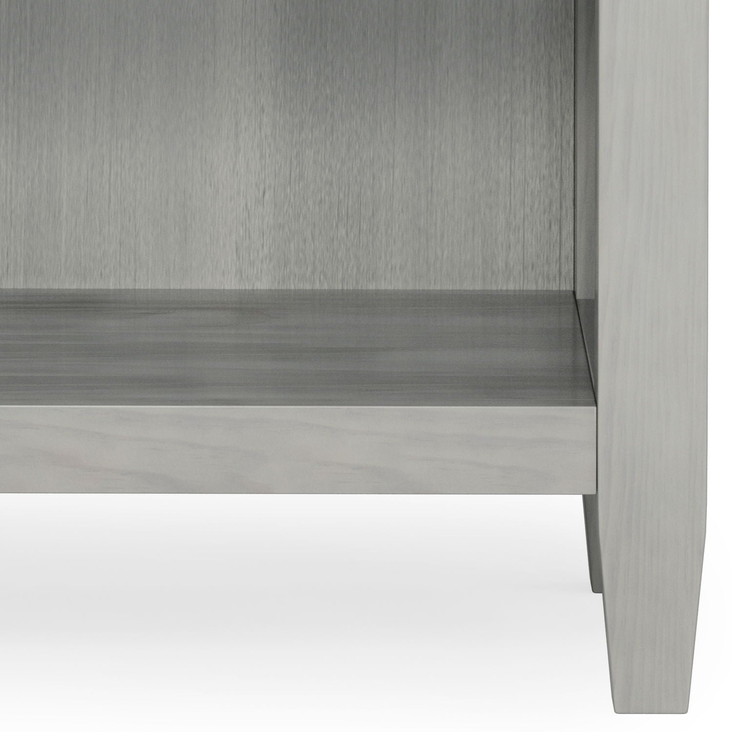 Lower portion of the Carlton - Bedside Table, Handcrafted, in light gray wood with four legs and an empty shelf, shown against a white background.