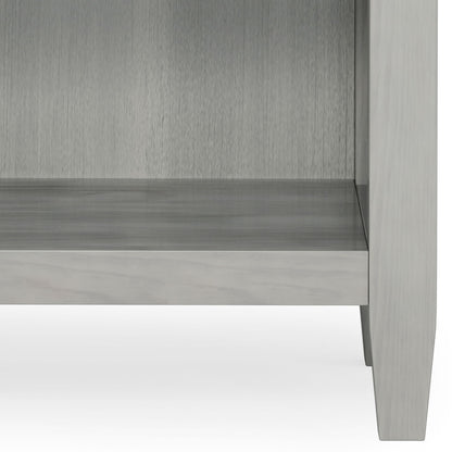 Lower portion of the Carlton - Bedside Table, Handcrafted, in light gray wood with four legs and an empty shelf, shown against a white background.