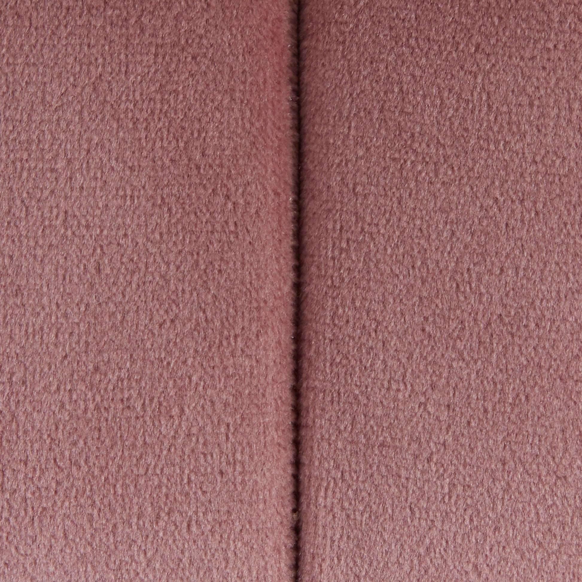 Close-up of the Braided - Versatile Round Ottoman, showing its soft pink textured fabric surface with a vertical seam down the center.