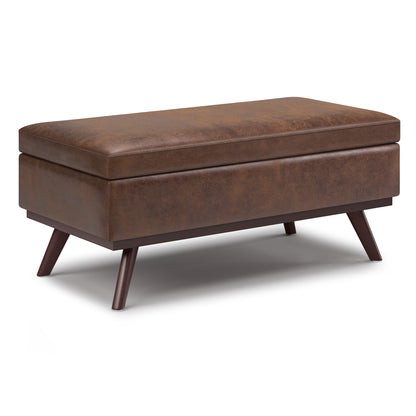 The Owen Lift Top Large Coffee Table Storage Ottoman features a rectangular brown leather design, cushioned top, angled wooden legs, and mid-century style.