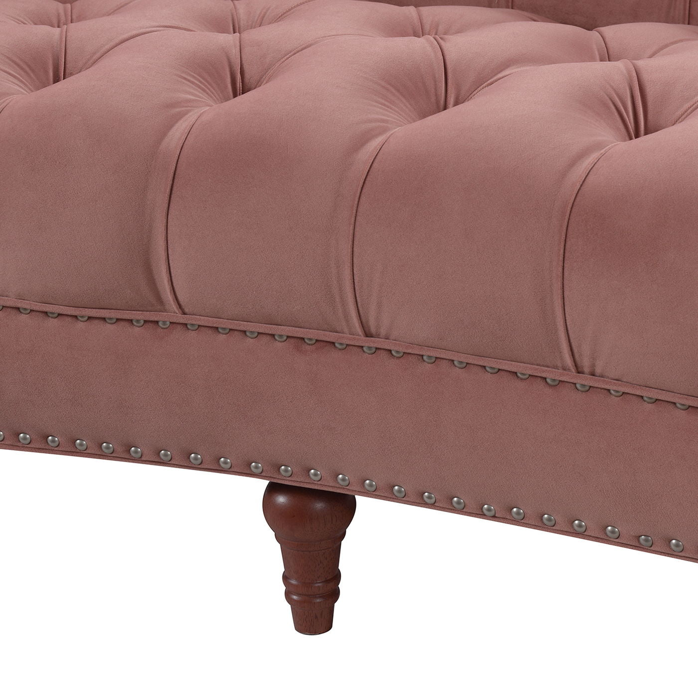 Close-up of the La Rosa - Victorian Chesterfield Tufted Sofa featuring pink upholstery, decorative tufted buttons, silver nailhead trim, and a dark wooden turned leg.