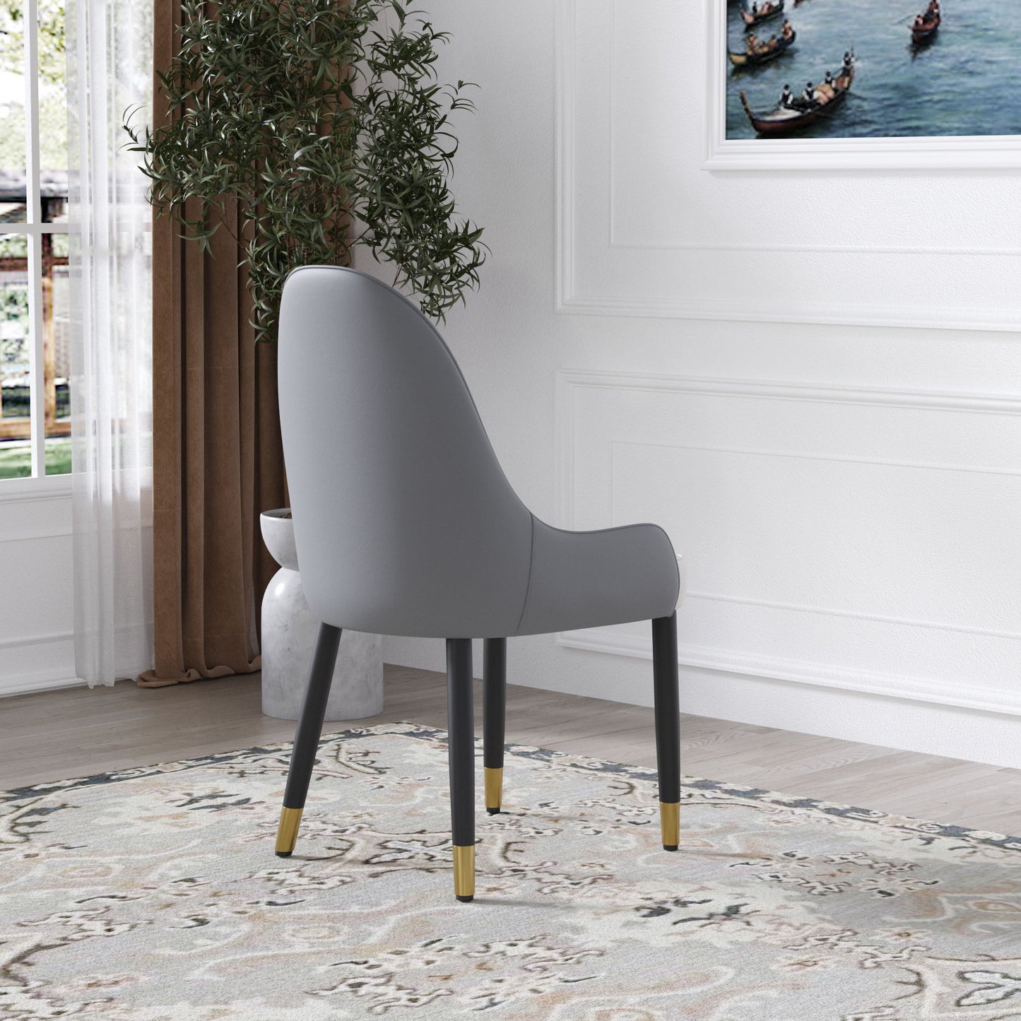 A set of two Modern PU Sponge-Filled Dining Chairs with solid wood metal legs sits on a patterned rug in a bright room with white walls, a large plant, and gondola artwork. Suitable for restaurants, living rooms, and more.