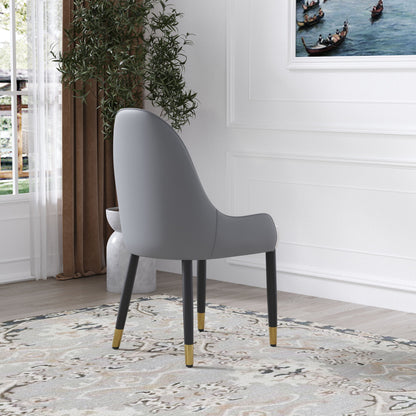 A set of two Modern PU Sponge-Filled Dining Chairs with solid wood metal legs sits on a patterned rug in a bright room with white walls, a large plant, and gondola artwork. Suitable for restaurants, living rooms, and more.