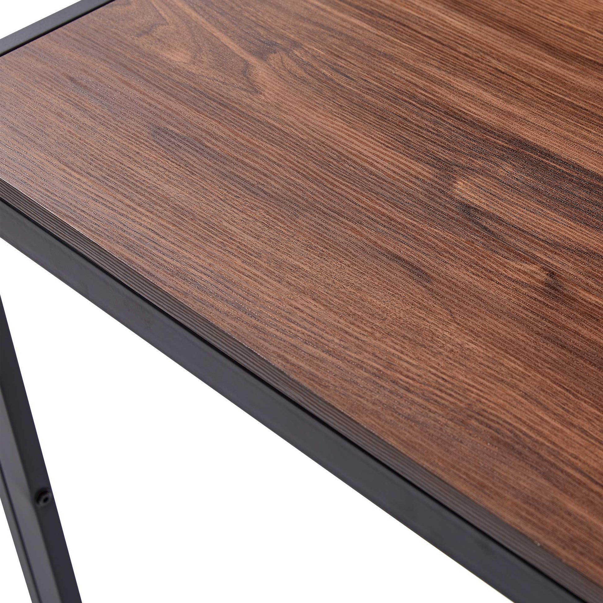 A close-up of the Creative Design Veneered MDF Wood Structure Rectangular Walnut Dining Table showcases its natural walnut wood grain tabletop with a sleek black metal frame and sturdy black metal legs.