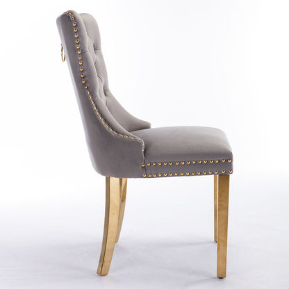 A side view of the Nikki modern dining chair shows gray velvet upholstery, tufted backrest with a gold ring handle, golden stainless steel-plated legs, and nailhead trim. Set of 2 high-end, solid wood contemporary chairs.