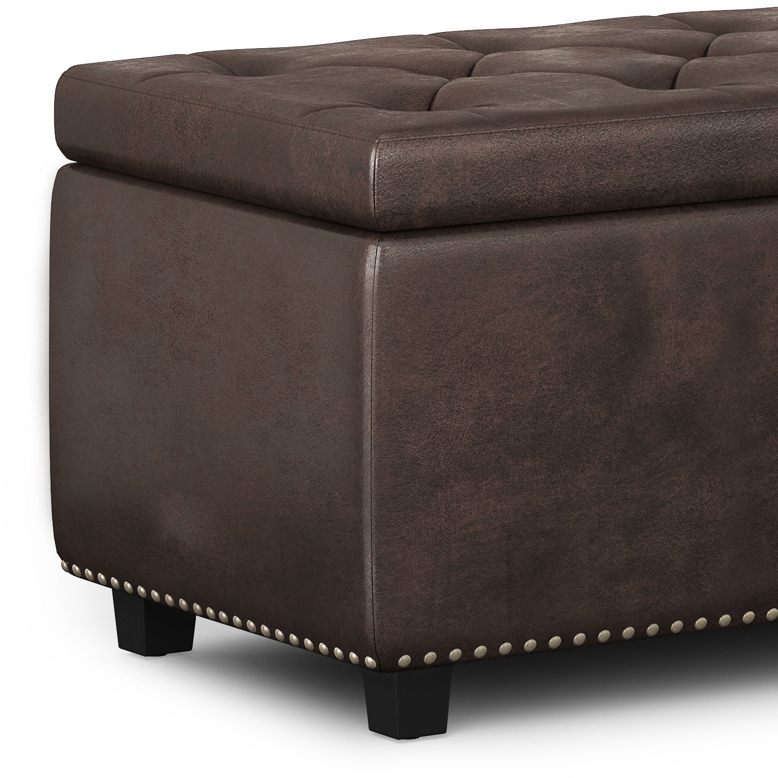 A close-up of the Hamilton Upholstered Storage Ottoman, featuring tufted dark brown leather, short black legs, and silver nailhead trim. The cushioned surface has a slightly distressed look for added character.