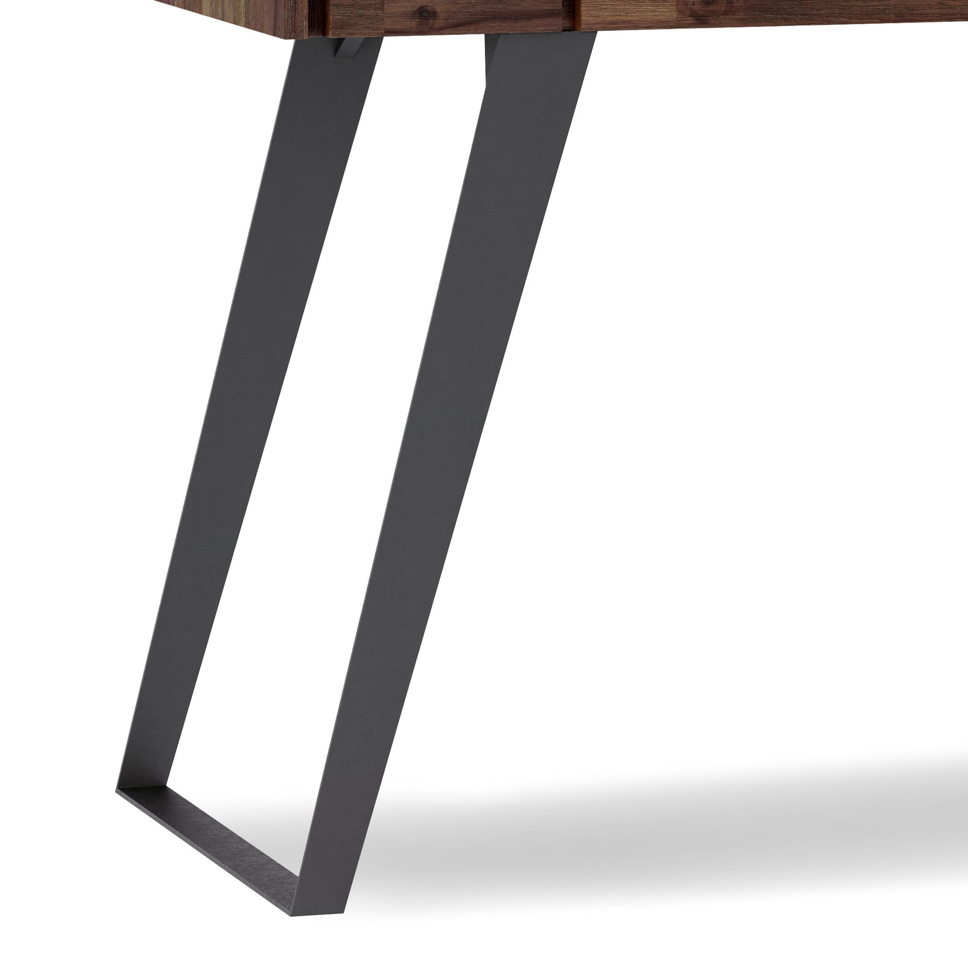 Close-up of the Lowry - Handcrafted Desk's black metal leg featuring an angled, geometric design, attached to its wooden tabletop against a white background.