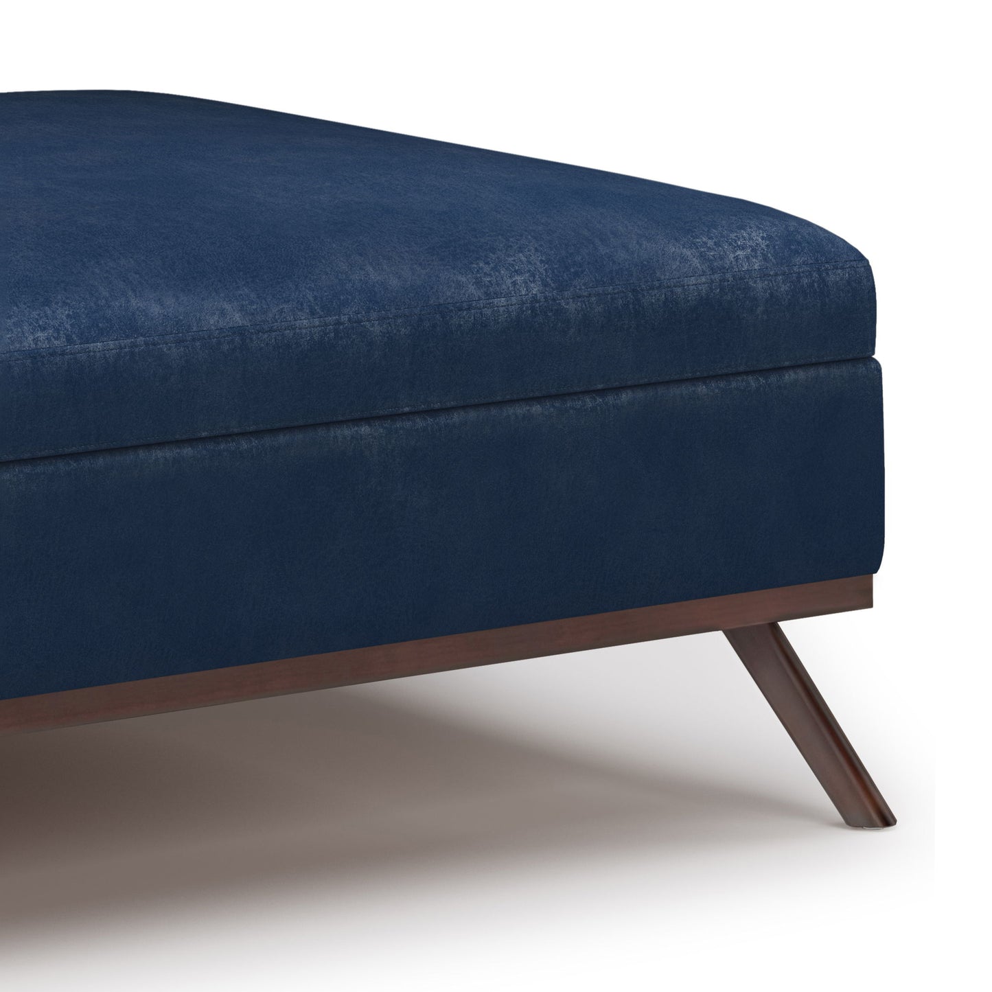 A close-up of the Owen - Multifunctional Square Coffee Table Storage Ottoman, featuring deep blue upholstery, a sturdy wooden frame, and angled legs against a light background.