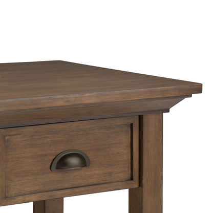 Close-up of the Redmond - Handcrafted End Table’s corner, highlighting its drawer with a metal cup handle and a smooth, natural wood finish.
