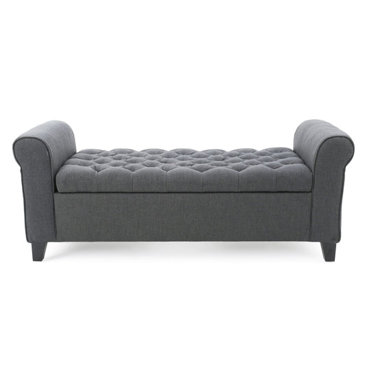 The Hayes bench features contemporary rolled arms, button tufting on a dark gray upholstered seat, and stands on four short angled legs.