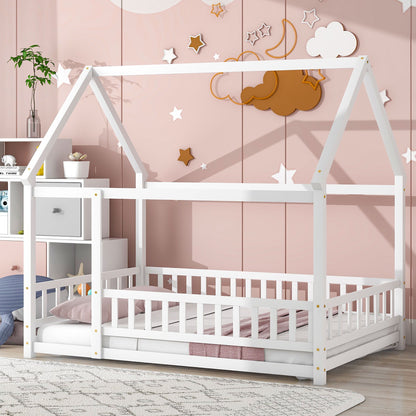 A pink-themed kids' room features the Floor Wooden Bed With House Roof Frame and Fence Guardrails in white. Above the bed are star and cloud wall decorations, with shelves nearby displaying toys and decor.
