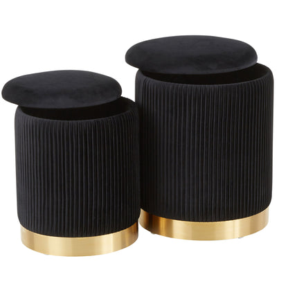 The Marla - Contemporary Nesting Pleated Ottoman Set includes two round, black velvet ottomans with vertical pleats, removable cushioned lids, and shiny gold metal bases. The smaller ottoman nests partially inside the larger one.