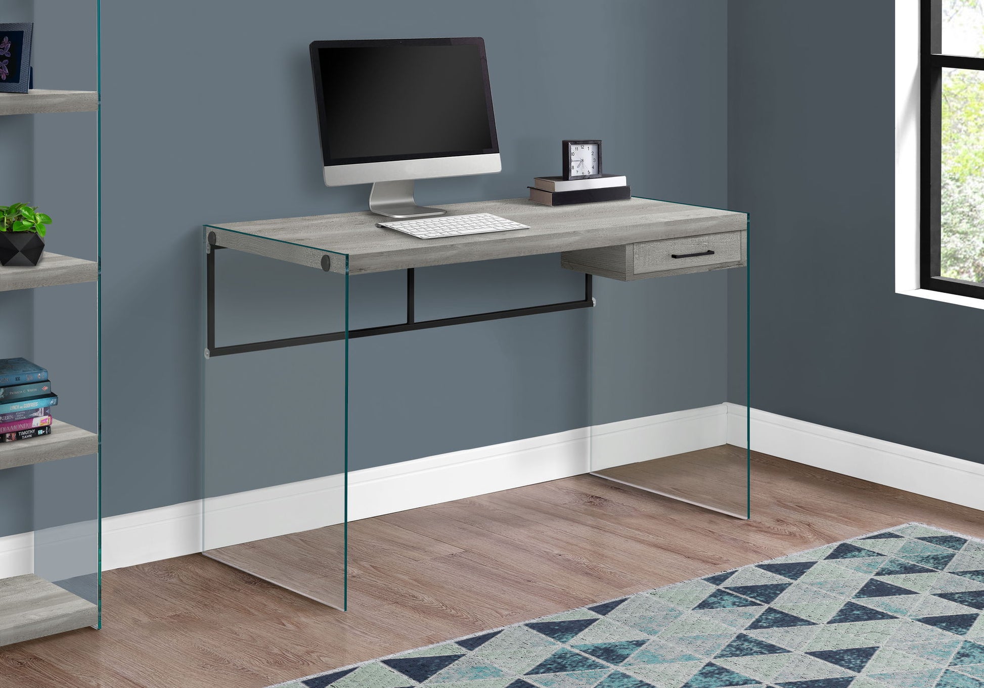 The Contemporary Design Computer Desk for Home Office features storage drawers, a light wood finish, glass side panels, and ample space for your computer setup. Perfect beside a window or bookshelf on a wooden floor.