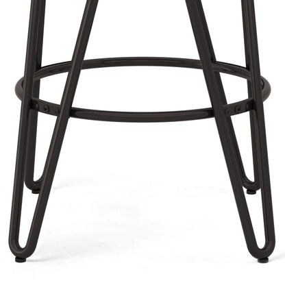Close-up of the black metal legs and circular footrest of the Simeon Multifunctional Metal Stool With Wood Seat, set against a white background.