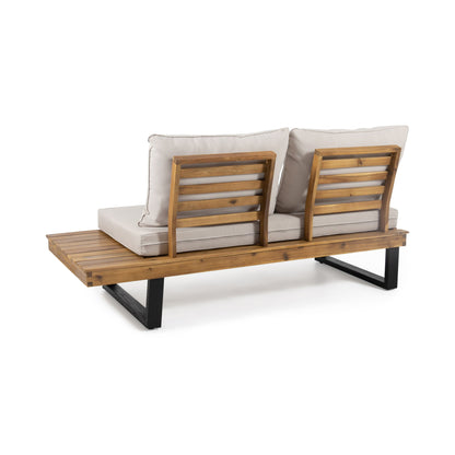 The Sebastian - 2 Seater Sofa is a wooden outdoor bench with two beige cushioned seats and backrests, slatted wood design, black metal legs, and an extended side platform for extra space.