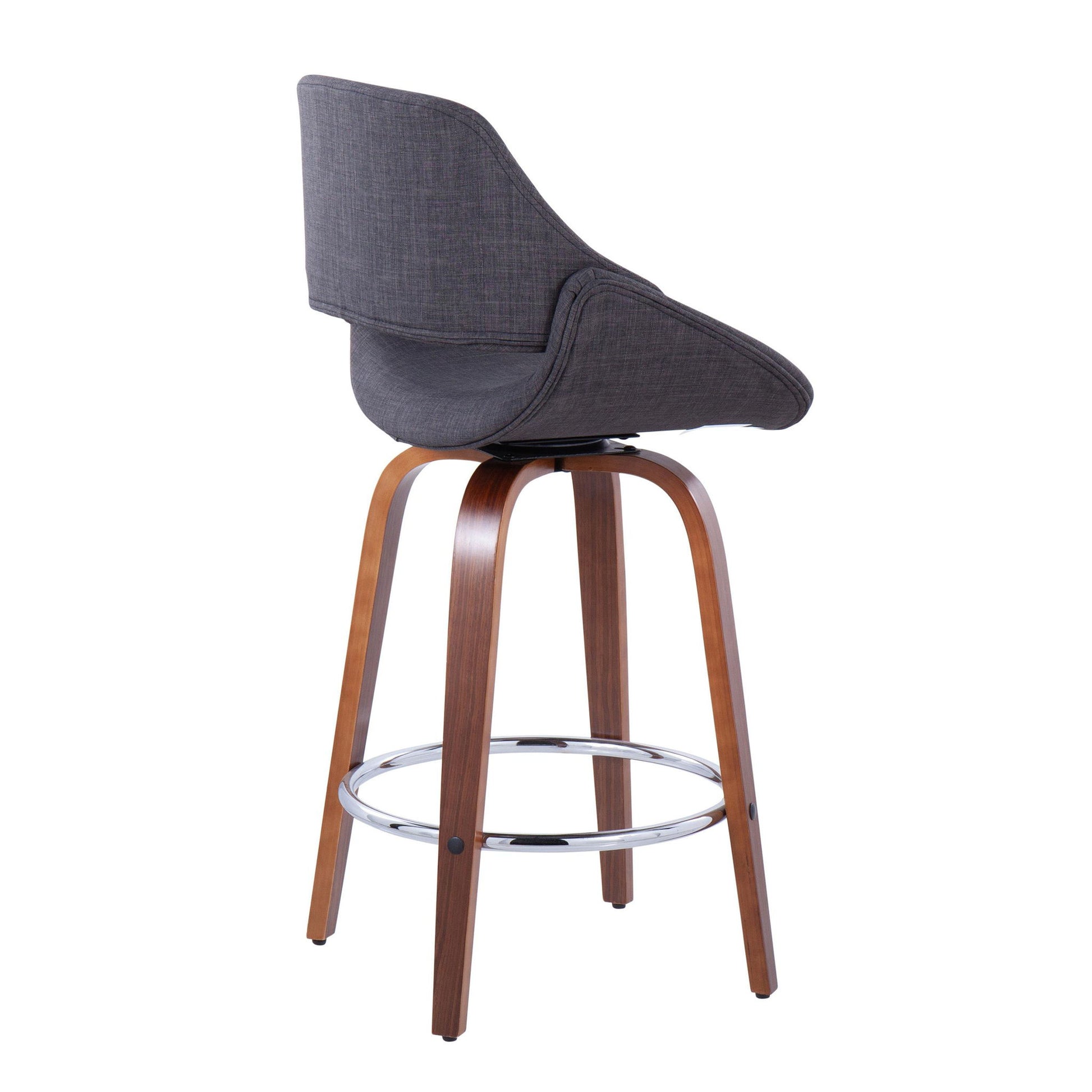The Fabrico Mid Century Modern Counter Stool Set features curved, padded dark gray fabric seats, wooden legs, and round chrome footrests. Shown from a rear side angle against a white background (set of 2, fixed height).