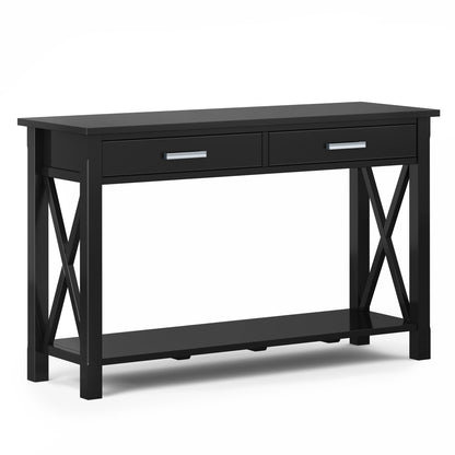 The Kitchener - Handcrafted Table is a black wooden console with two drawers, chrome handles, an open lower shelf, X-shaped side supports, and a rectangular top, shown against a plain white background.