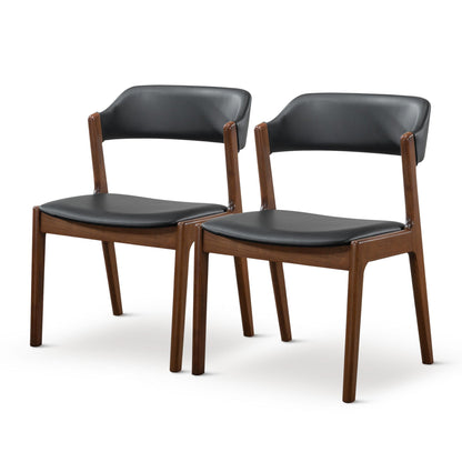 The Enzo Dining Chair Set (2) features black cushioned seats and backs with brown wooden frames, shown side by side on a white background.