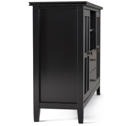 The Artisan Handcrafted Tall TV Media Stand features a black wood finish, two drawers, glass-paneled doors, and metal handles; displayed from a side angle on a white background.