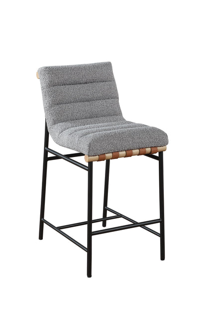 The Lahni 17" Boucle Fabric Counter Height Chair features a textured, cushioned gray seat with ribbed design, wooden edge accents, and a supportive backrest atop slender black metal legs with footrests.