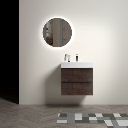 A minimalist bathroom features the Alice wall-mounted vanity with a one-piece white sink. A round, backlit mirror hangs above, three toiletries rest on the vanity, and patterned tiles accentuate the floor.