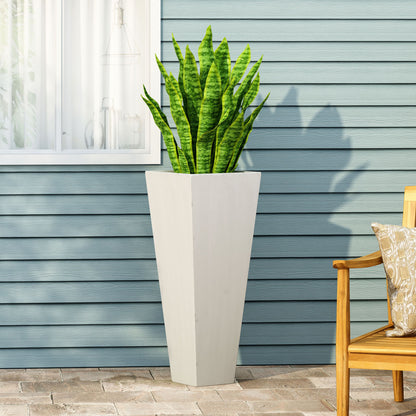 An Outdoor Modern Cast Stone Planter with a snake plant sits on a brick patio against light blue paneled siding, near a window and a wooden chair decorated with a patterned cushion.