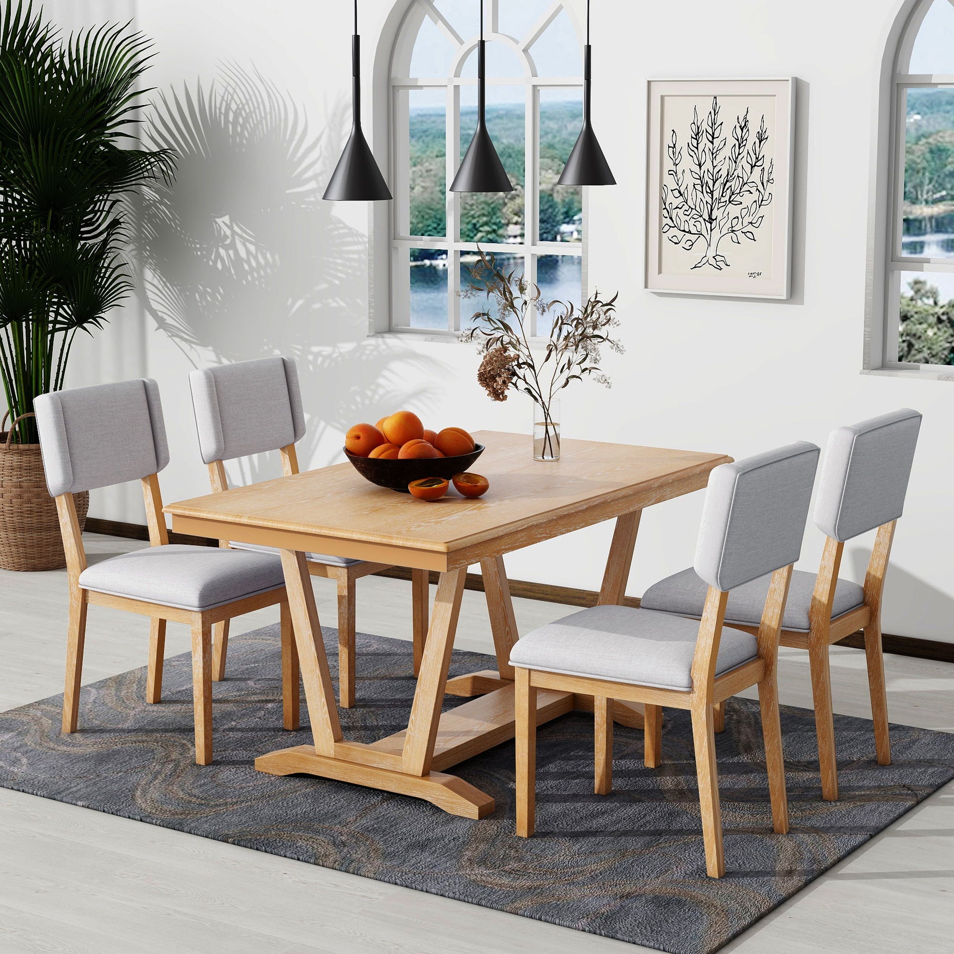 A modern dining room featuring the Topmax 5 Piece Rustic Dining Table Set with a rectangular trestle-base table and four upholstered chairs, a bowl of oranges centerpiece, pendant lights, wall art, large window, plants, and a patterned rug.