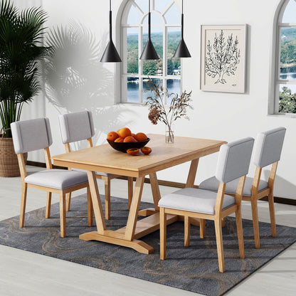 A modern dining room featuring the Topmax 5 Piece Rustic Dining Table Set with a rectangular trestle-base table and four upholstered chairs, a bowl of oranges centerpiece, pendant lights, wall art, large window, plants, and a patterned rug.