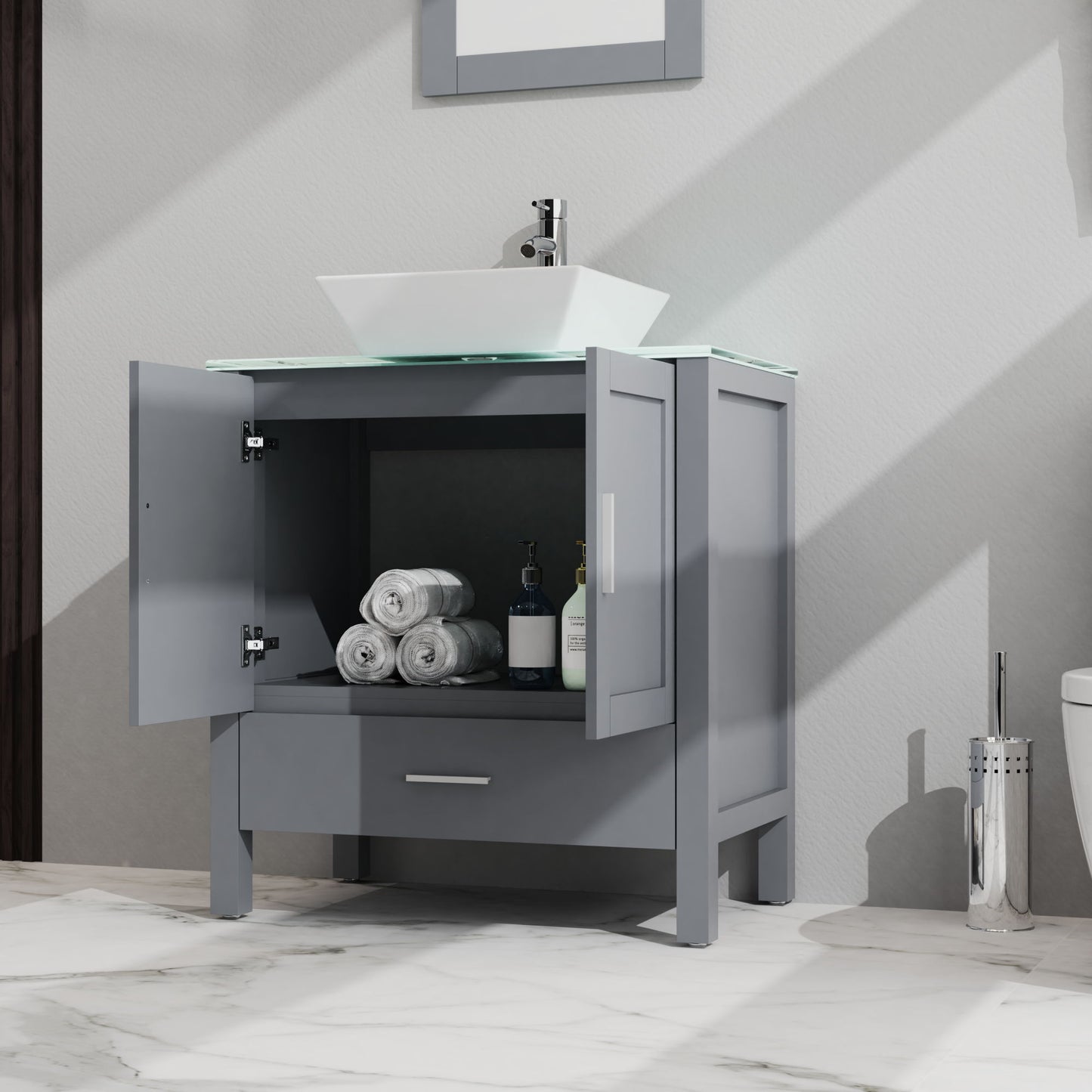 The Bathroom Vanity And Sink Combo Glass Top Cabinet With Mirror features open doors displaying rolled towels and toiletries, a modern white vessel sink on top, and is set against elegant white marble flooring.