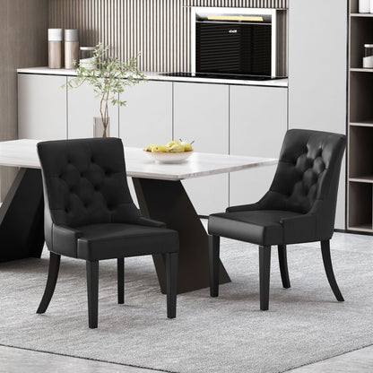 A set of two Cheney Contemporary Dining Chairs with tufted upholstery sit by a modern rectangular table on a light gray rug in a contemporary kitchen featuring white cabinets and minimalist decor.