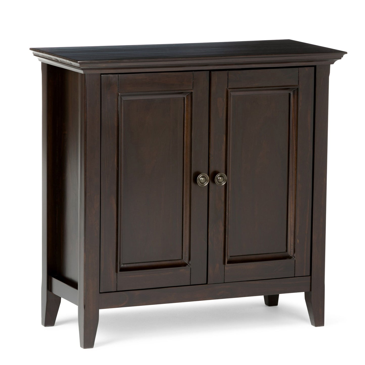 The Amherst - Handcrafted Low Storage Cabinet features dark wood, two paneled doors with round metal handles, and four short legs. Its simple, classic design fits seamlessly into a variety of home interiors.