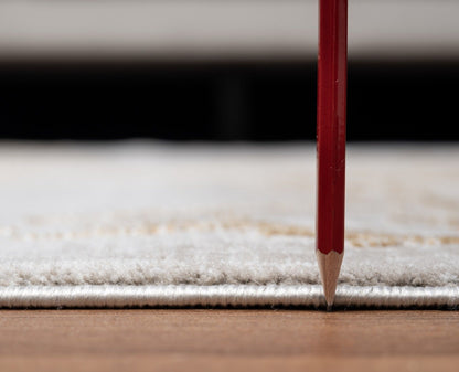 A close-up of the Elegance - GC_CNC6004 Area Rug with a red pencil standing vertically, highlighting the rug’s thickness above a wooden floor.