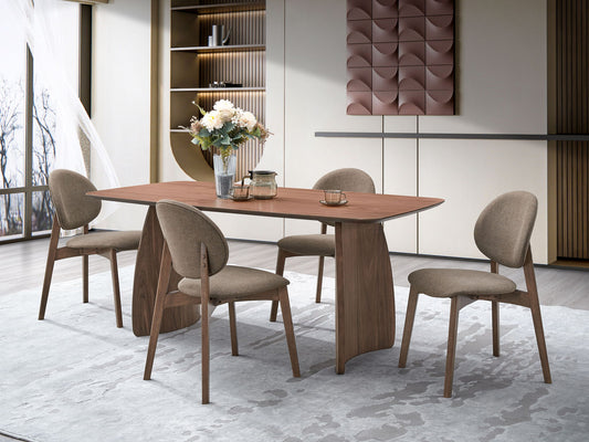 A modern dining room features the Hadasa - Dining Table - Walnut, four upholstered chairs, a vase of flowers, and cups. Neutral tones and natural light from large windows enhance the minimalist, stylish atmosphere.