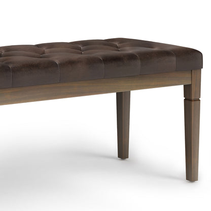 The Waverly - Upholstered Tufted Ottoman Bench features a dark brown tufted cushion and four straight wooden legs, shown close-up on a white background.