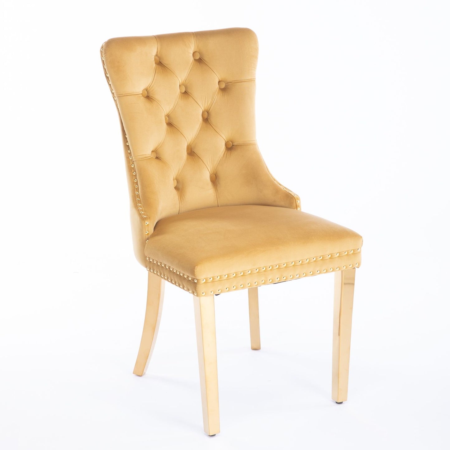 The Nikki dining chair set features modern velvet upholstery, a high button-tufted back, nailhead trim, and golden stainless steel legs, offering contemporary style and luxury. Shown against a plain white background.