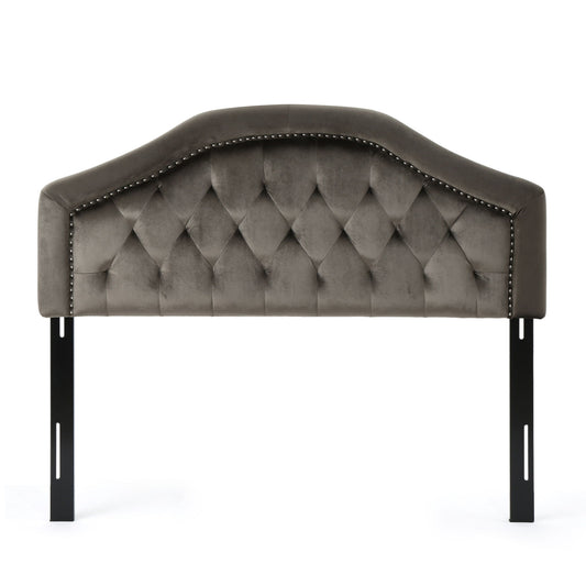 The Kaarina - Contemporary Tufted Fabric Headboard features gray upholstery, a curved top, diamond tufted design, nailhead trim along the edge, and is supported by two black metal legs.