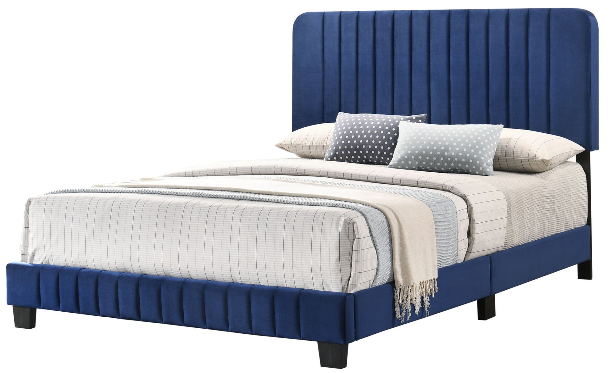 The Lodi - Bed features a tall, vertical-stitched blue upholstered headboard and matching frame, accented with white and gray plaid bedding, a beige blanket, and multiple patterned pillows for a modern look.