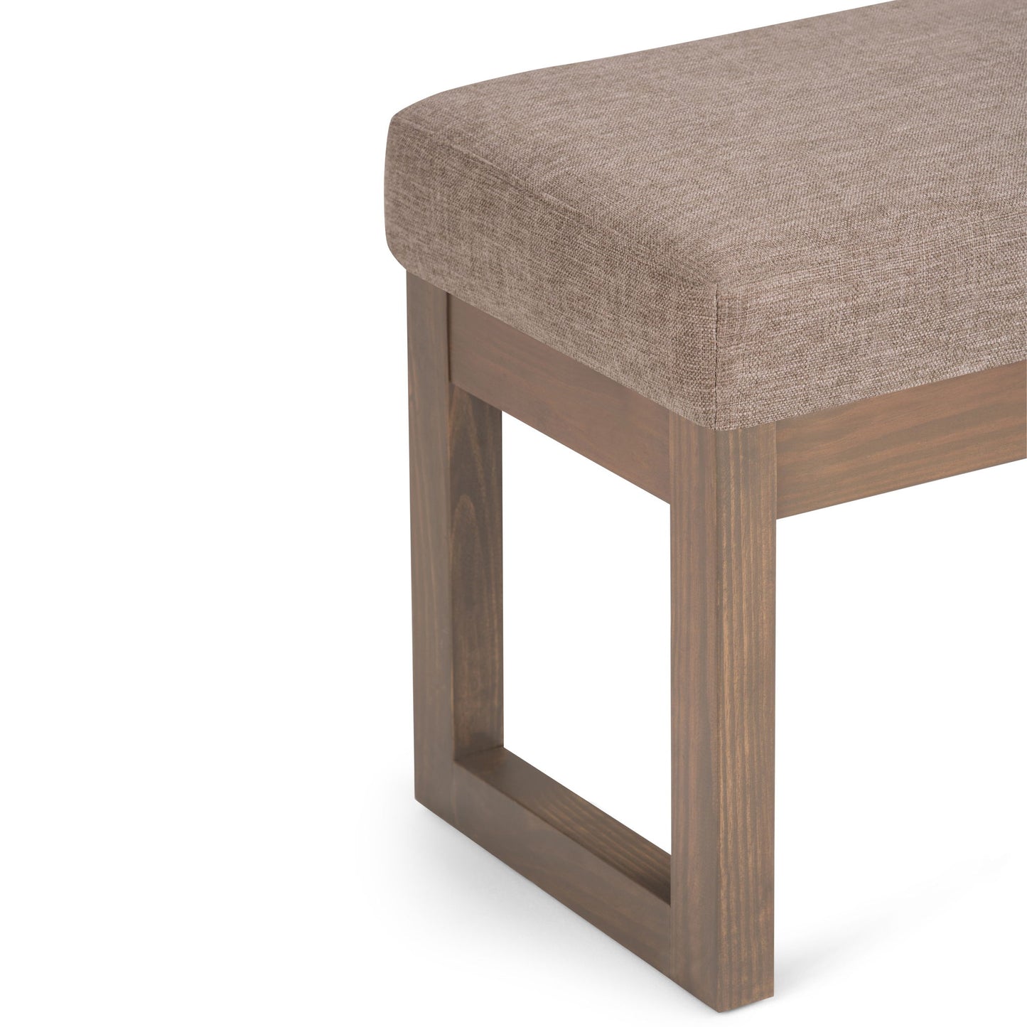 Close-up of the Milltown - Upholstered Ottoman Bench featuring a cushioned light brown fabric seat and rectangular open-frame wooden leg.