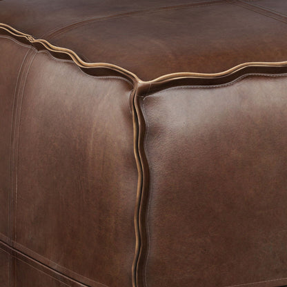 Close-up of the Brody - Versatile Square Pouf in brown leather, highlighting detailed stitching, neat edge seams, and a smooth yet subtly textured surface.