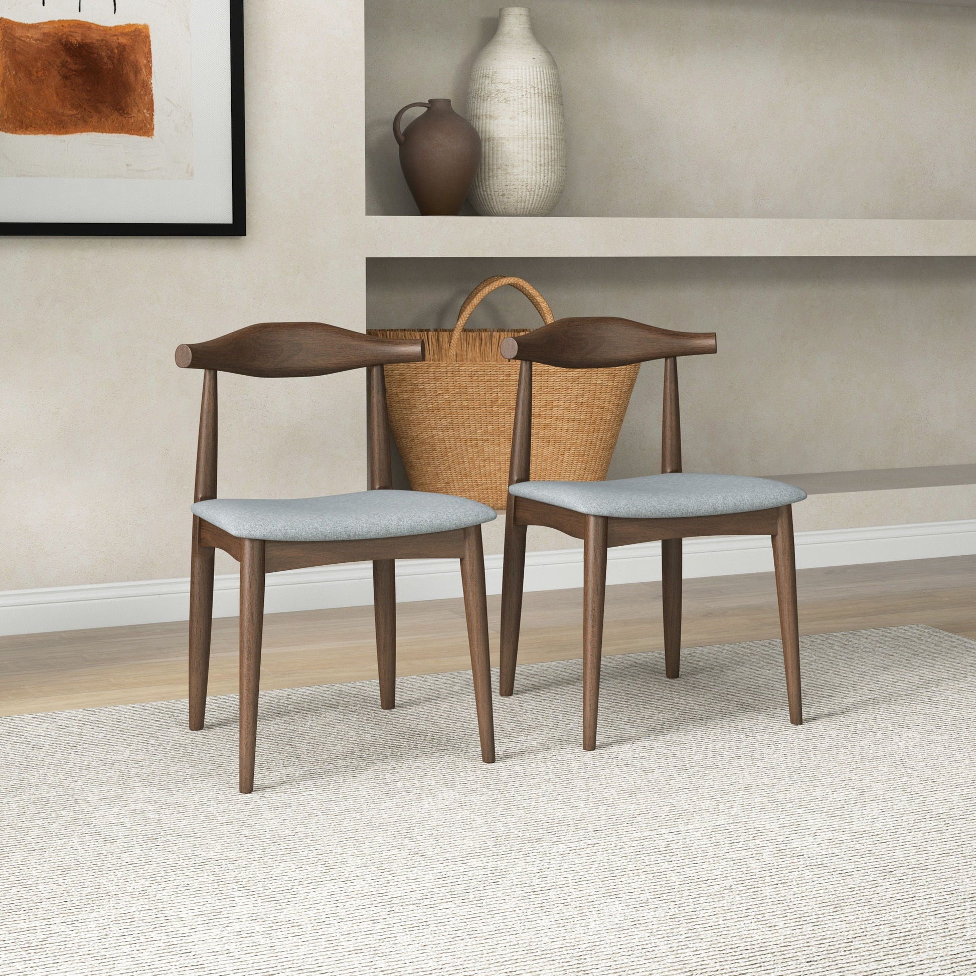 The Destiny - Modern Dining Chairs (Set of 2) with light gray seats are arranged on a textured beige rug, complemented by a large woven basket and decorative vases displayed on shelves against a light wall.