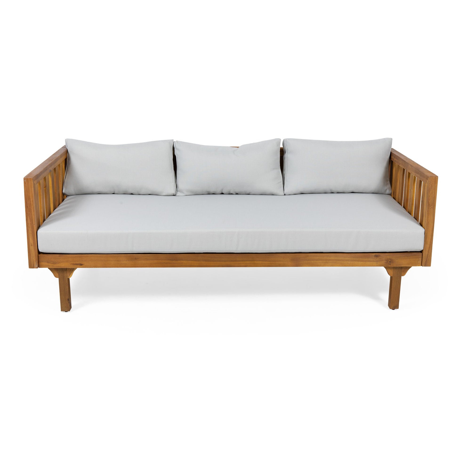 The Claremont 3 Seater Daybed features a teak acacia wood frame with slatted armrests, light gray water-resistant seat and back cushions, and three matching back pillows, shown against a white background.