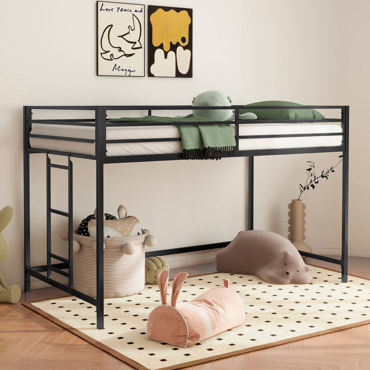 The Adam - Junior Twin Loft Bunk in black features green bedding and is set above a play area with animal toys, baskets, a dotted rug, playful wall art, and vine-shaped decor.