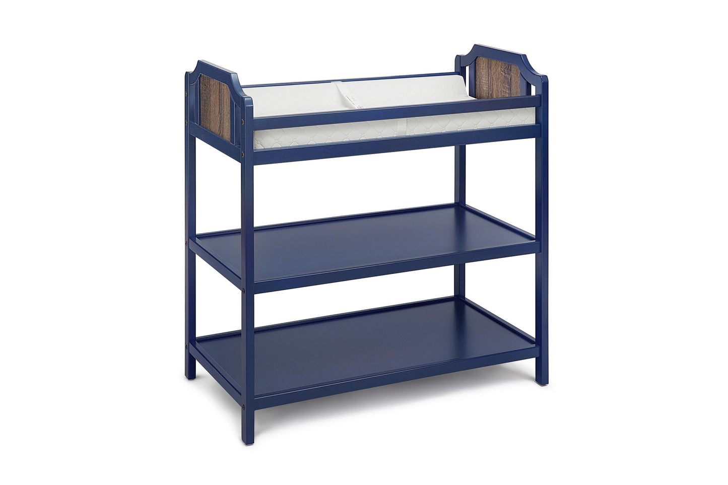 The Brees - Changing Table is navy blue wood, features two lower storage shelves, white cushioned changing pad on top, and wood accent panels at each end.