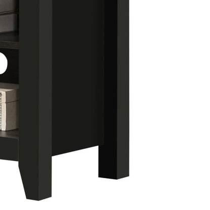 A close-up of the Benito TV Stand shows its black wooden finish, open lower shelf with books, and a round cable management hole on the back panel.