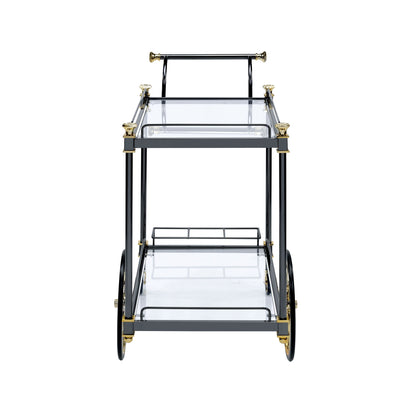 Front view of the Cyrus Clear Glass Serving Cart in black and gold, featuring two glass shelves, large back wheels, small front legs, and a top handlebar.