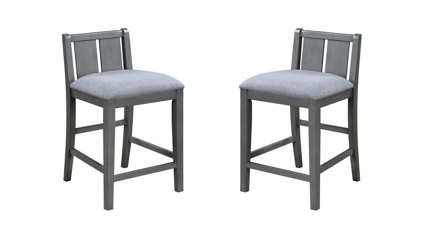 The Graham 3 Piece Small Space Counter Height Dining Set features two gray wooden chairs with light gray upholstered seats and slatted backs, shown on a white background.