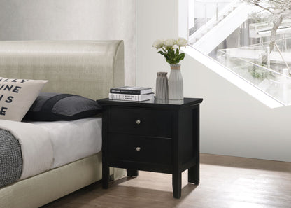 A modern bedroom features a beige upholstered bed beside the Primo - Nightstand, which holds white vases with flowers, books, and a magazine, all set by a large window offering an outdoor view.